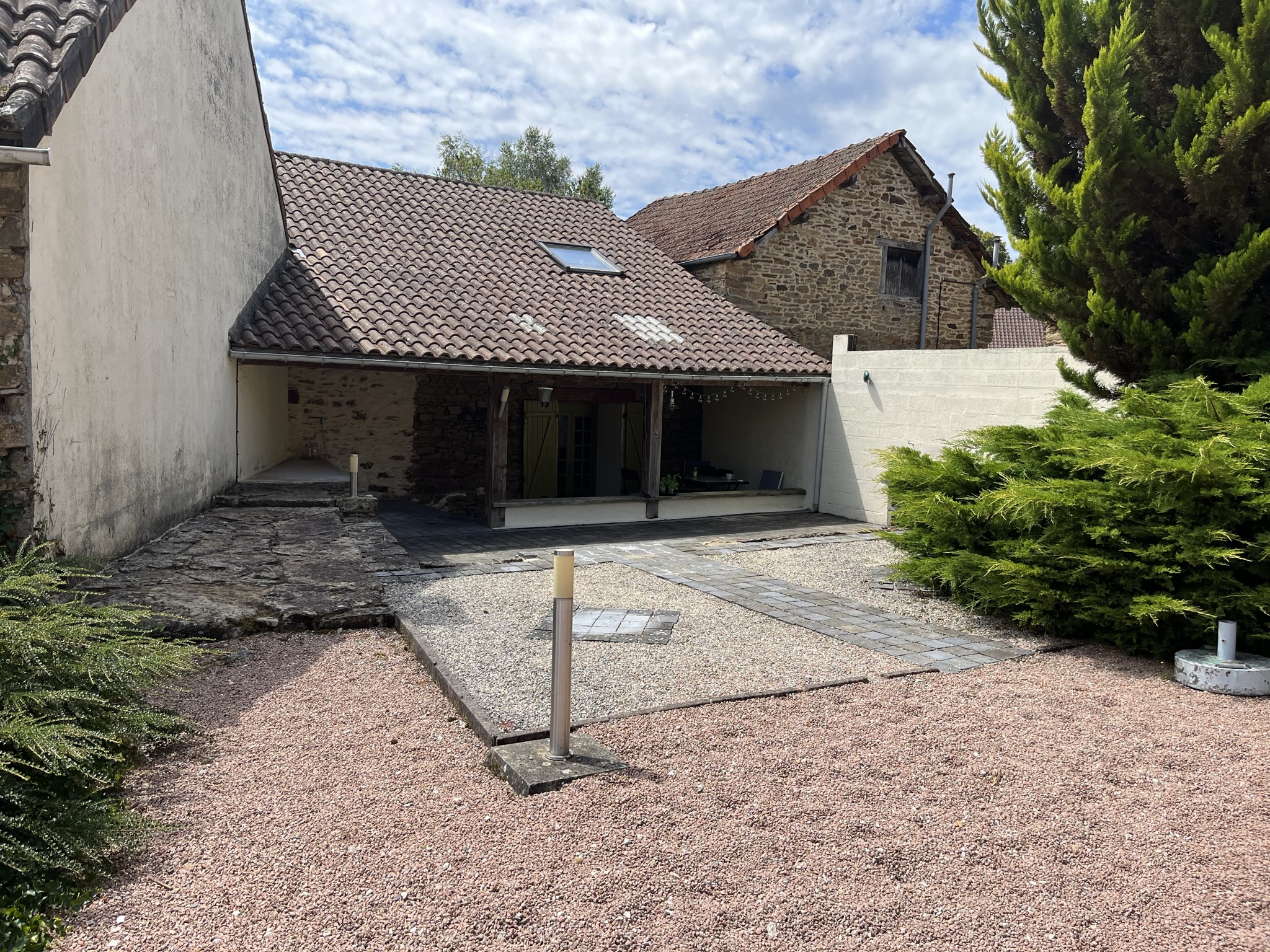 Stone farmhouse with a gravel courtyard